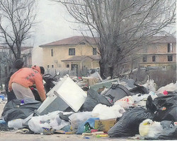 Alcuni ragazzi di Casal di Principe cercano tra i rifiuti che occupano un viale di quasi due chilometri